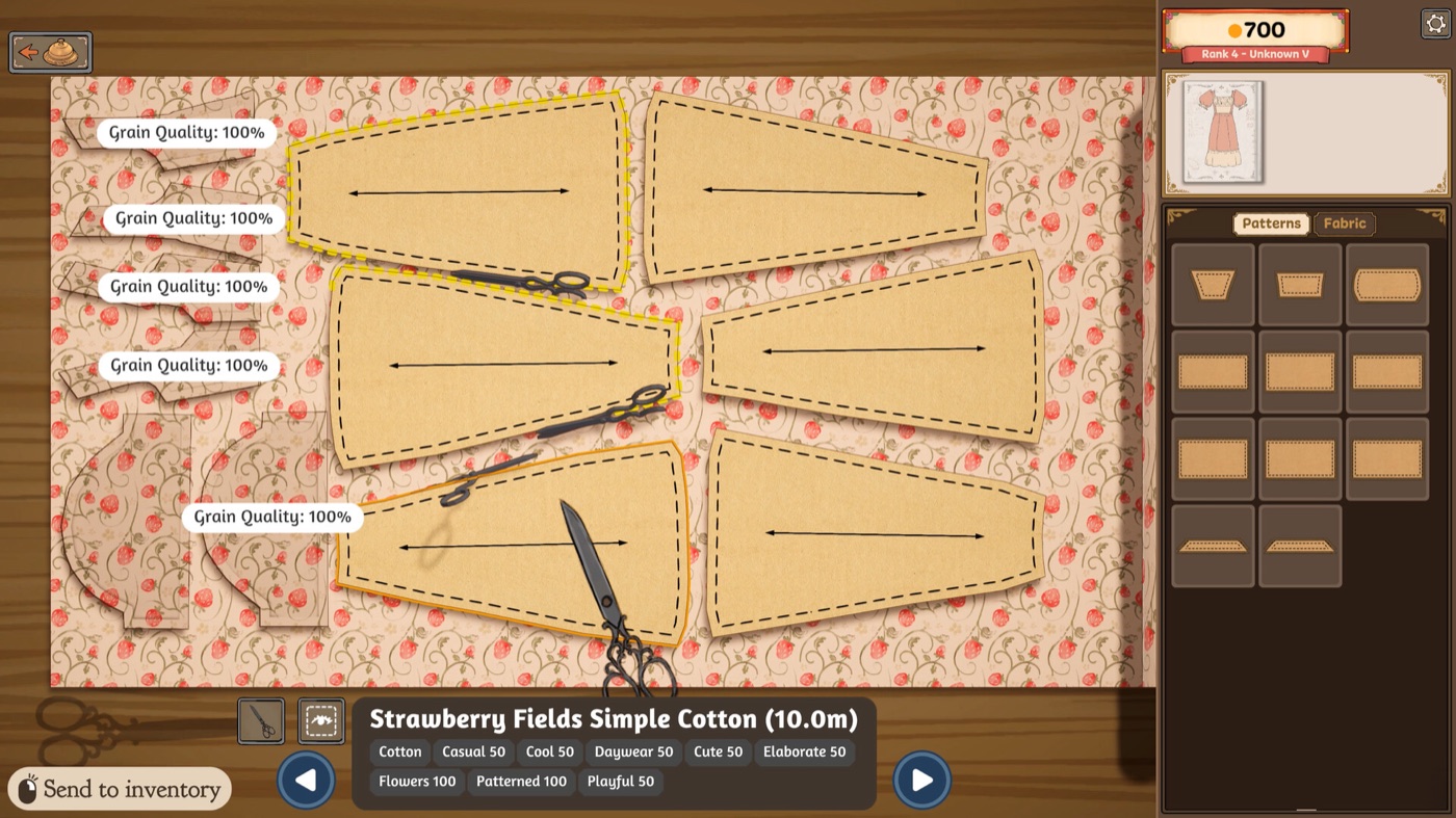 Pattern pieces laid out on a patterned cotton roll on the cutting table, each piece labelled with its grain quality